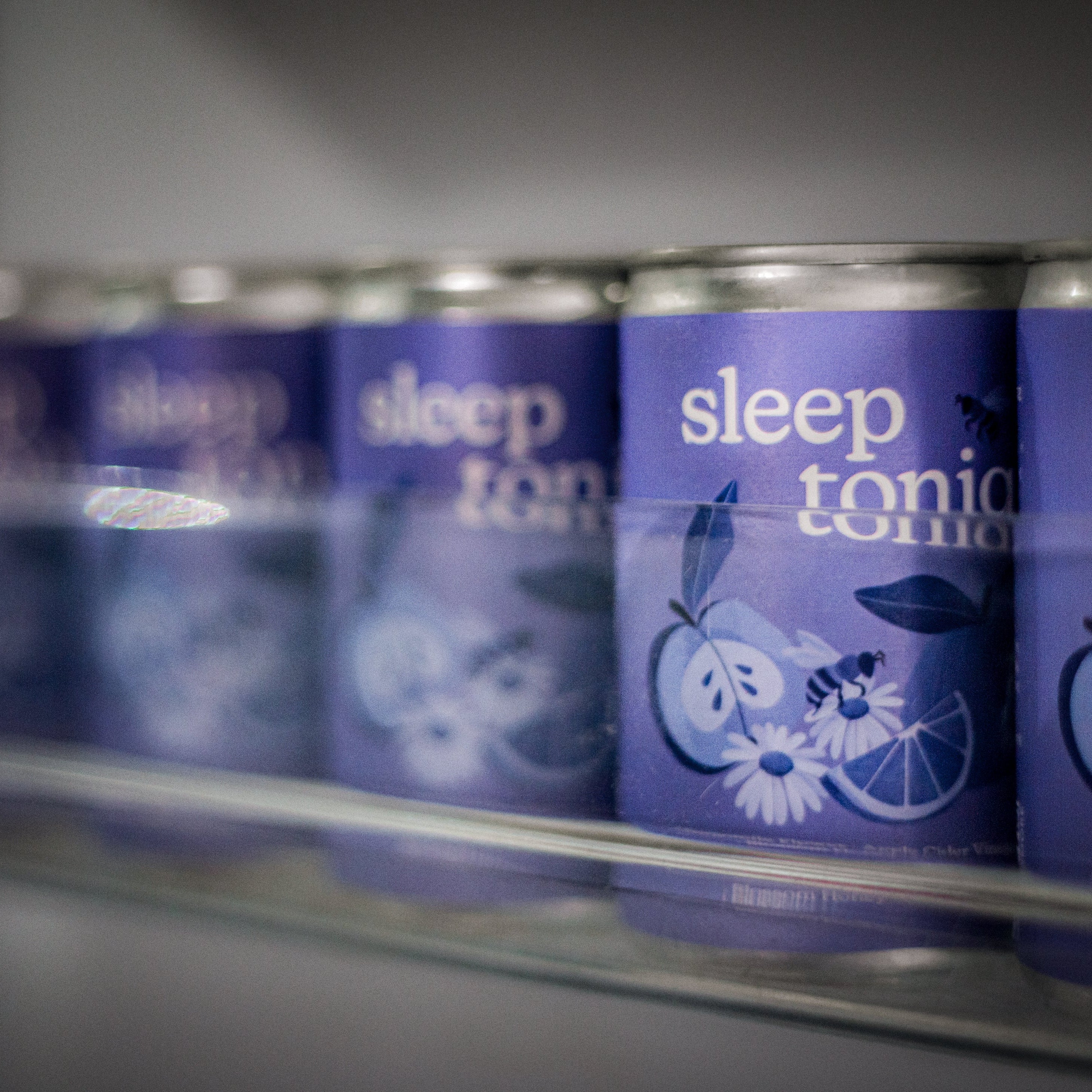 A row of sleep toniq cans in the fridge